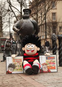 Dennis the Menace poses with an enlarged version of the new Beano stamp in front of the Desperate Dan statue in Dundee-765443
